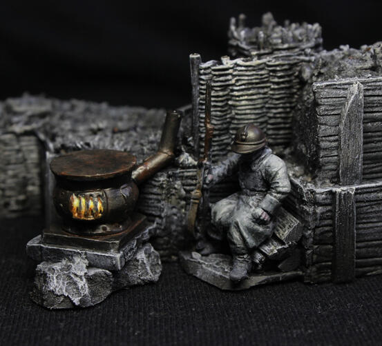 A close-up of a trench section, with a French soldier taking rest near a potbelly stove.
